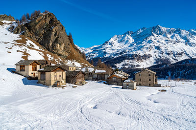 View of the village of grevasalvas, and lake sils, in engadine, switzerland, in winter.