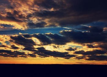 Scenic view of landscape against dramatic sky