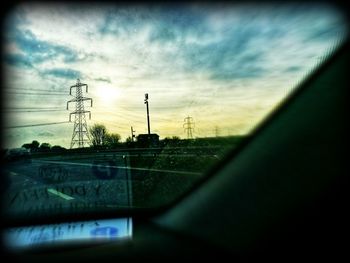 View of landscape seen through car windshield