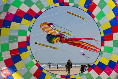 People at beach seen through hot air balloons