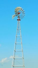 Old metal windmill with blue sky background 