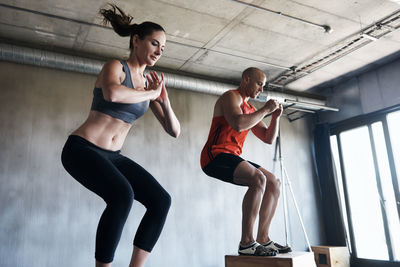 Man and woman exercising in gym