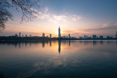 Buildings in city at sunset