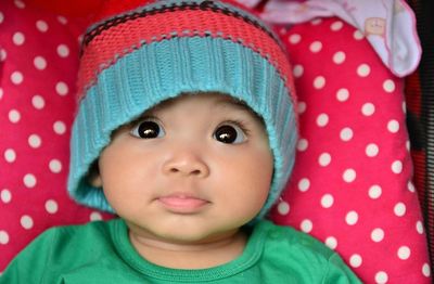 Close-up of cute baby girl wearing knit hat