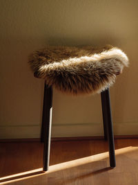 Close-up of stool with sheepskin