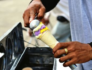 Cropped image of hand holding cigarette