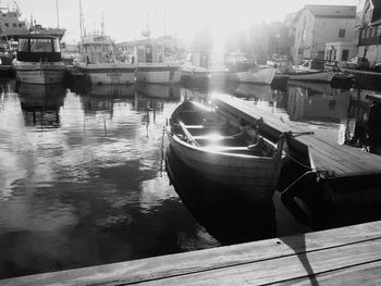 Boats moored on river in city