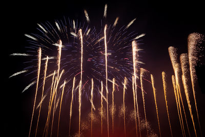 Low angle view of firework display at night