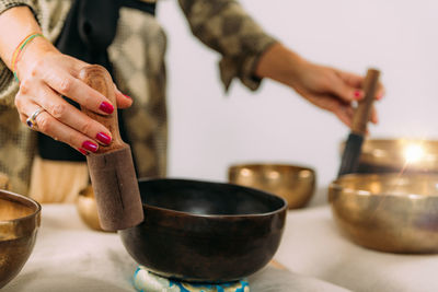 Woman playing tibetan singing bowl in sound healing therapy