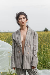 An asian model poses in a field of yellow flowers for a clothing brand, polyethylene 