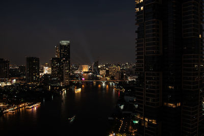 Top view cityscape of bangkok at night with lighting cruises on chao phraya river view