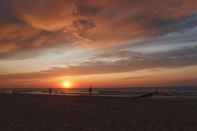 Scenic view of beach against sky during sunset