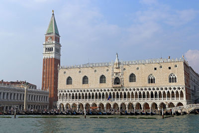 The bell tower of san marco and the palazzo ducale seen from the grand canal during a boat trip.