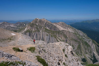 Mountaineer observing the landscape of the mountains of the laga gran sasso abruzzo