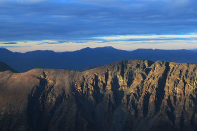 Scenic view of mountains against sky at sunset