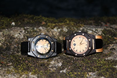 Close-up of wristwatches on rock