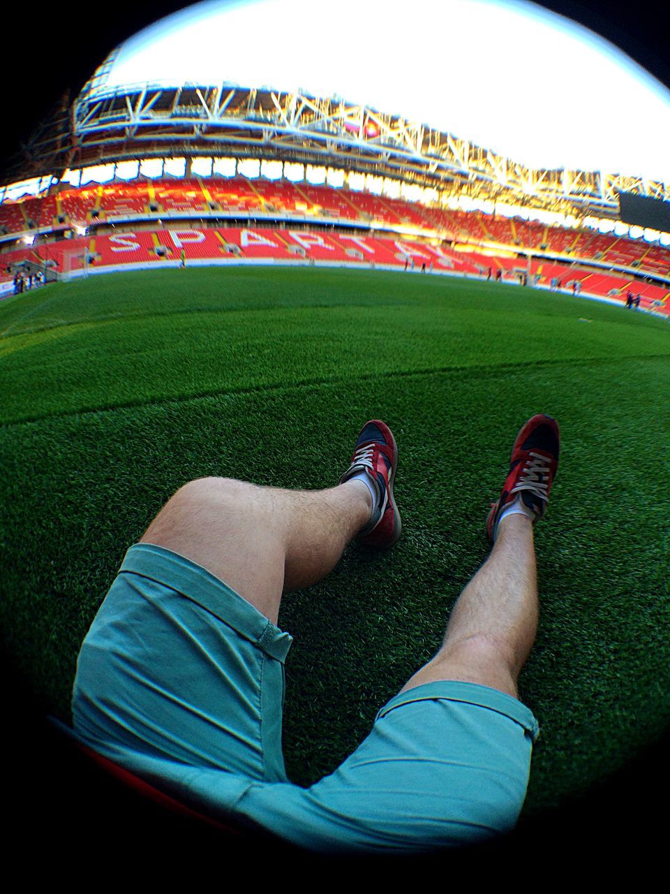 low section, person, lifestyles, leisure activity, grass, relaxation, personal perspective, barefoot, field, green color, sitting, men, lawn, shoe, resting, relaxing