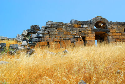 Old ruin on field against clear sky