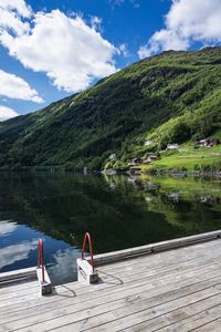 View of jetty on lake against mountains