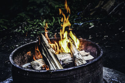 Close-up of burning wood in container