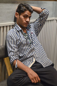 Young man sitting on seat at home