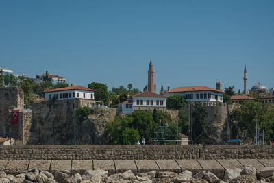 Buildings against clear blue sky