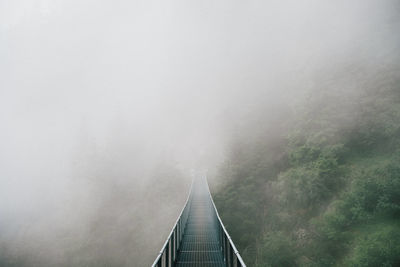 Footbridge in foggy weather