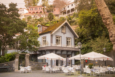 Houses by trees and buildings in city