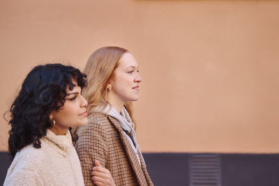 Smiling young women walking outdoors