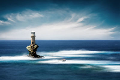 Scenic view of lighthouse in sea against sky