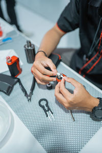 Midsection of man working on table