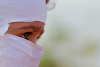 Child face close up with wearing face mask protection from covid-19 coronavirus