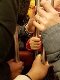 Midsection of couple holding hands