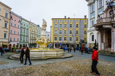 People around fountain at town square