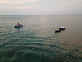 Boat sailing in sea against sky