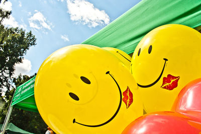 Close-up of yellow balloons against sky