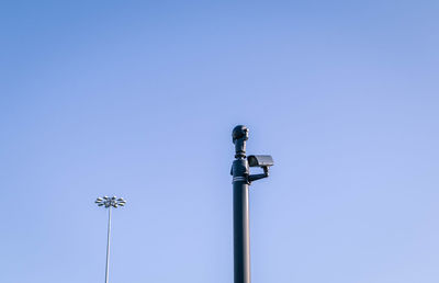 Low angle view of floodlight against clear blue sky