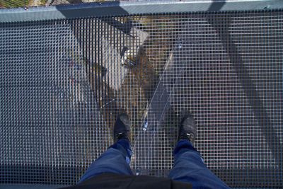 Low section of men standing on footbridge