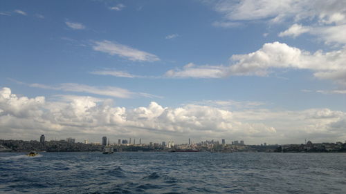 Scenic view of sea and buildings against sky