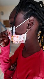 Portrait of a young girl wearing a mask to protect herself from coronavirus