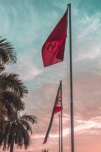 Low angle view of flag against sky during sunset