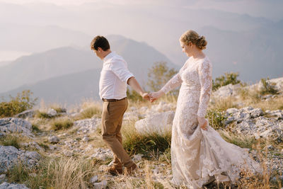 Rear view of couple standing on land