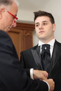 Man assisting groom at home