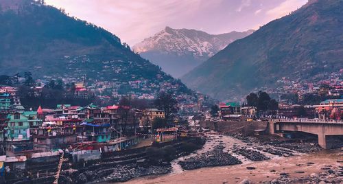 High angle view of townscape and mountains against sky