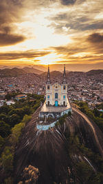 Aerial view of buildings in city during sunset