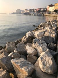 Rocks by sea against sky