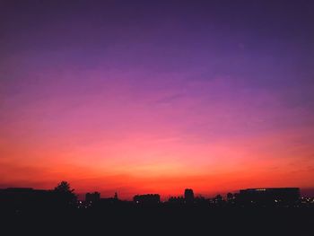 Silhouette buildings against sky during sunset