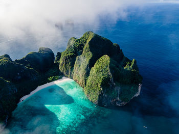 High angle view of rocks on sea shore against sky