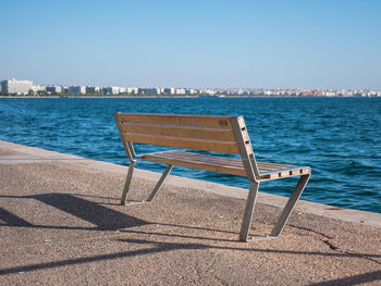 Chairs on beach against clear sky