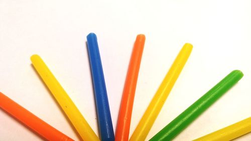 Close-up of colored pencils against white background